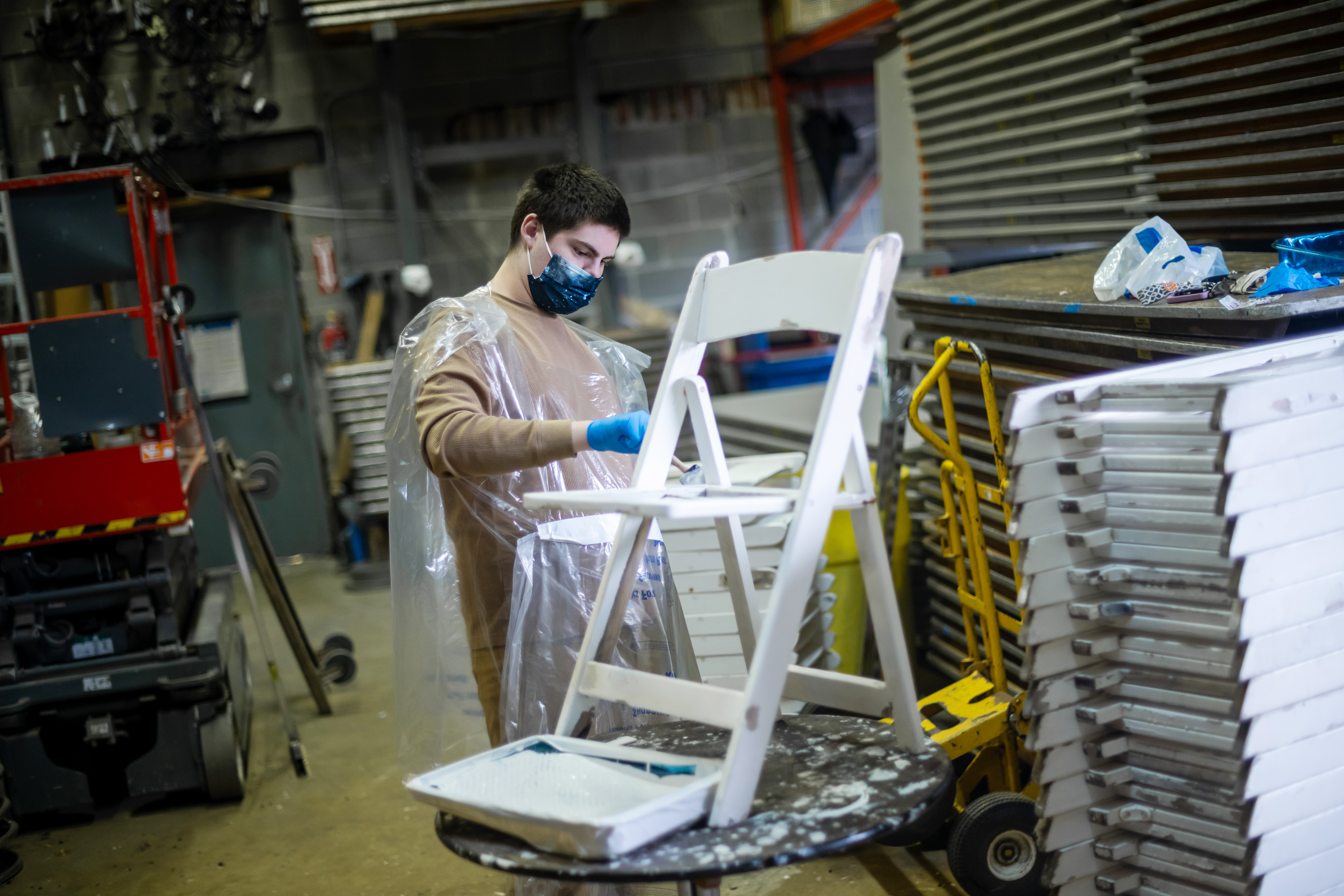 Cedar Lane student Curtis Roberts repaints a chair while working at his school-sponsored internship at Brooke Rental Center.